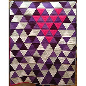 A purple, white, grey and pink modern equilateral triangle quilt.