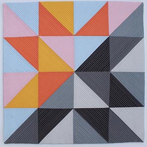 A bright, modern, half square triangle quilt.